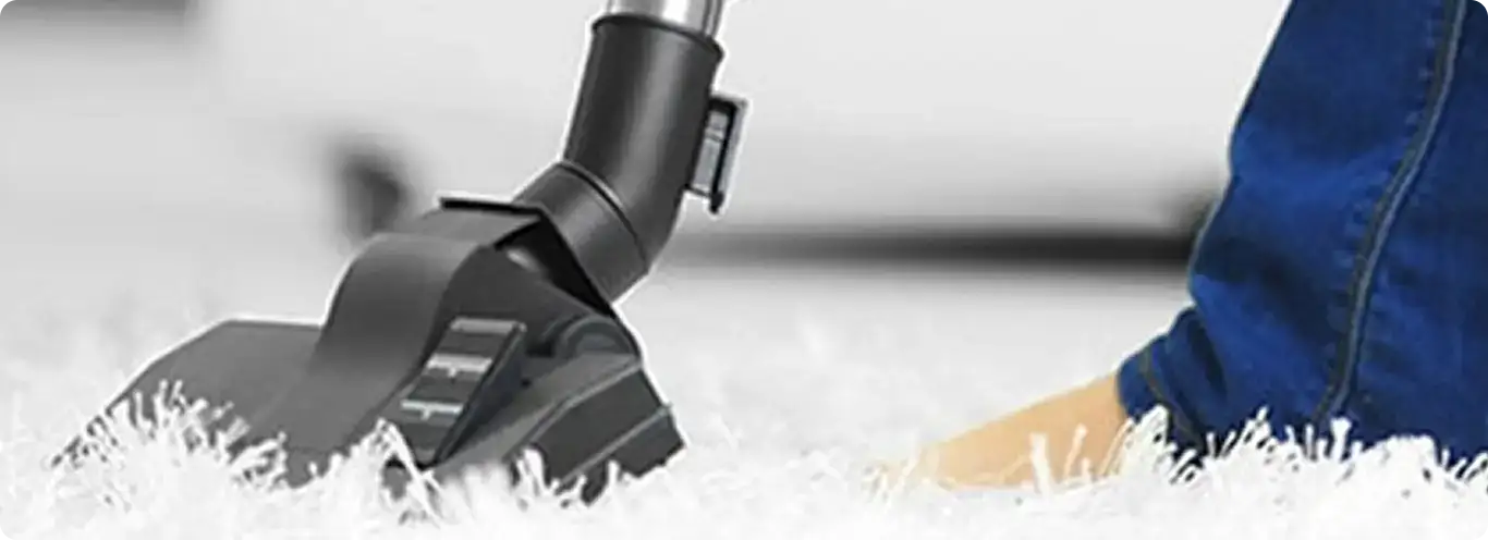 Close-up of a professional vacuuming a white carpet in Lodi.